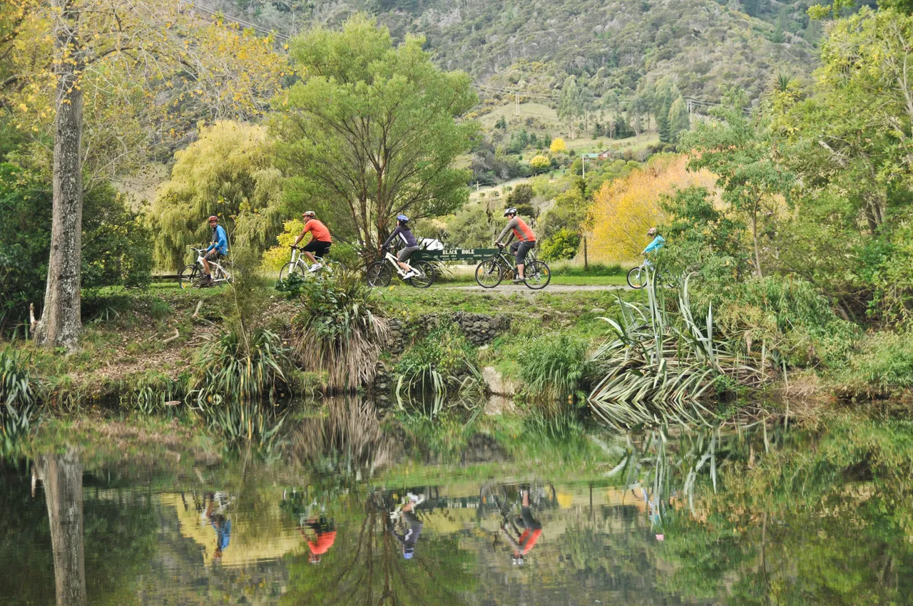 Cyclists at Black Hole Along Maitai River