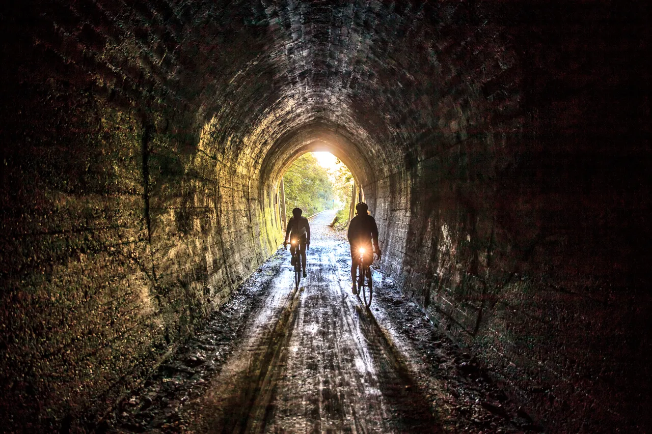 Cyclists Inside Spooners Tunnel on Tasman's Great Taste Trail