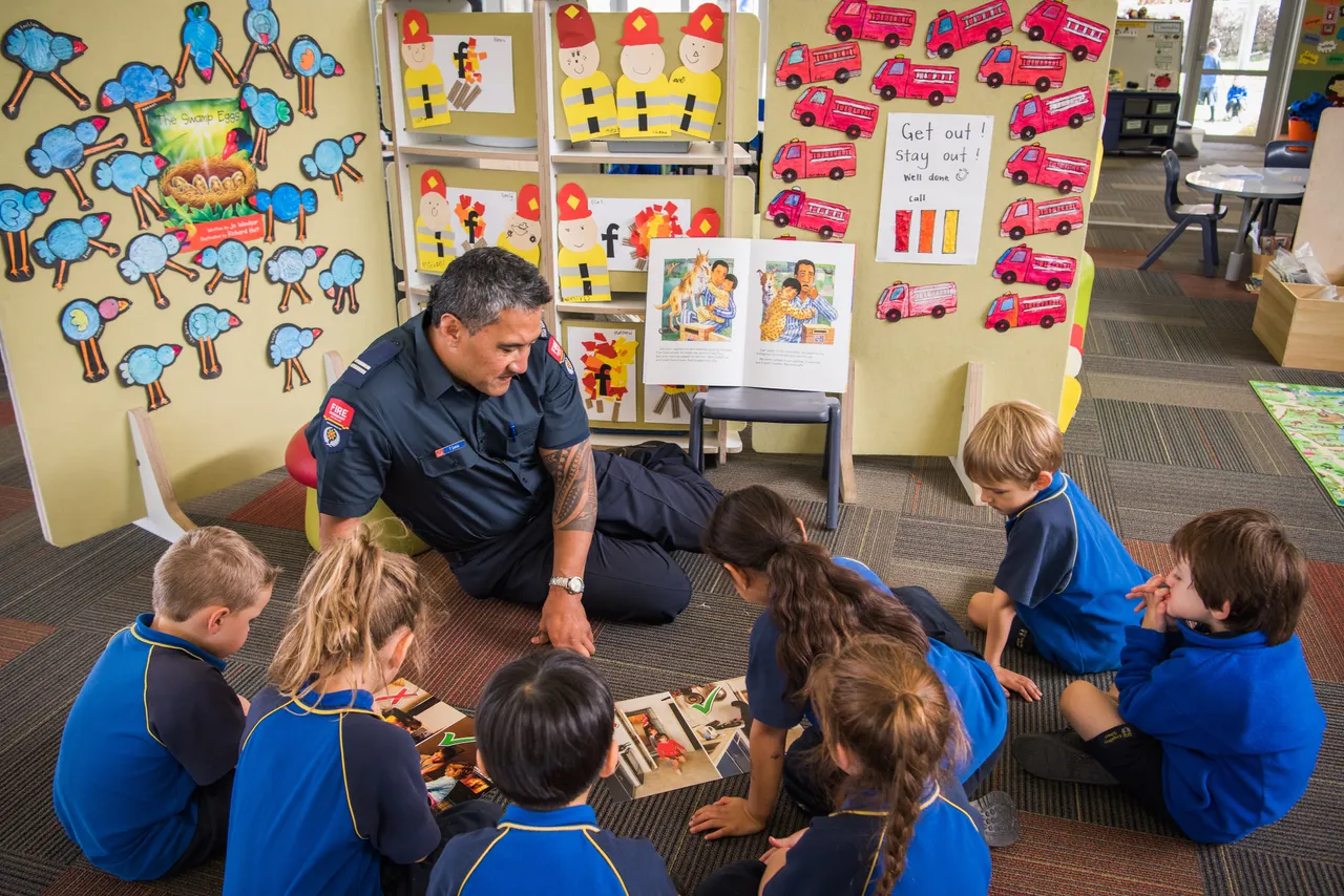 Firefighter teaching young children about fire safety