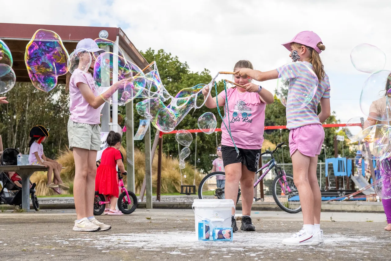 children playing with giant bubbles