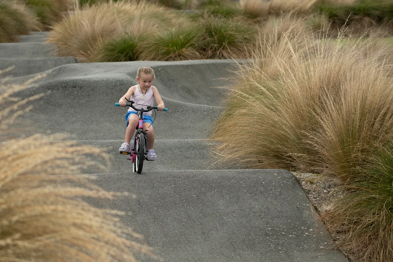 Child riding a bmx on a bike track