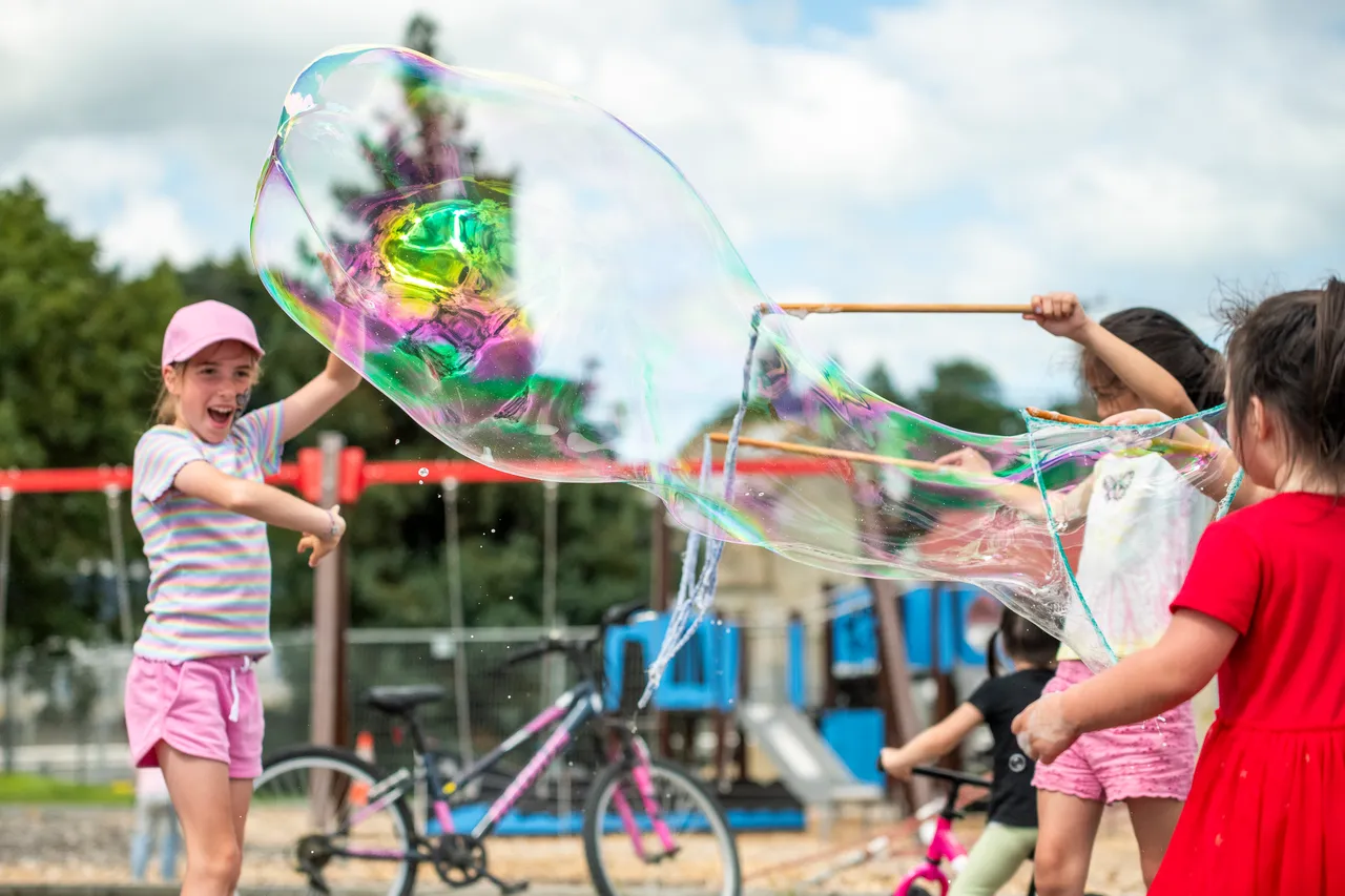 children playing with giant bubbles
