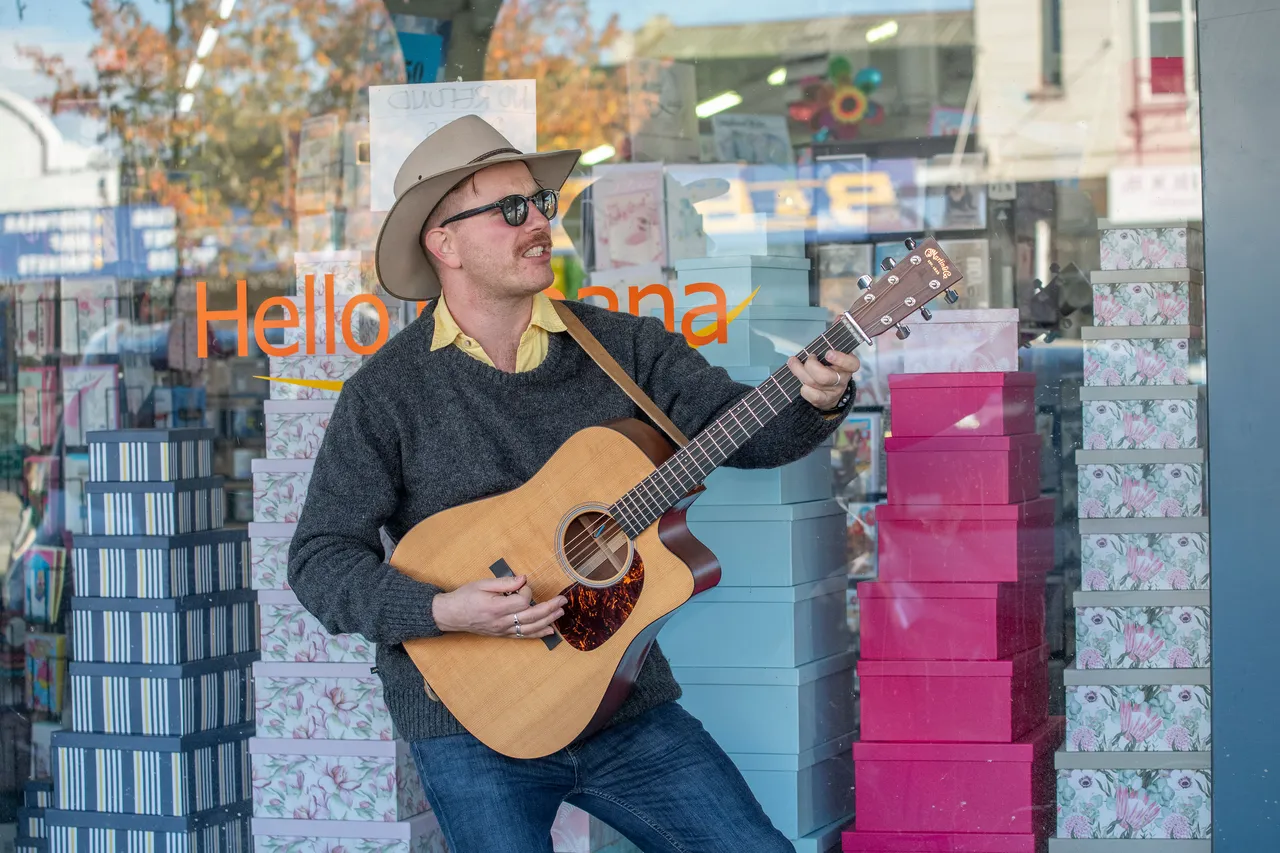 Man busking playing guitar