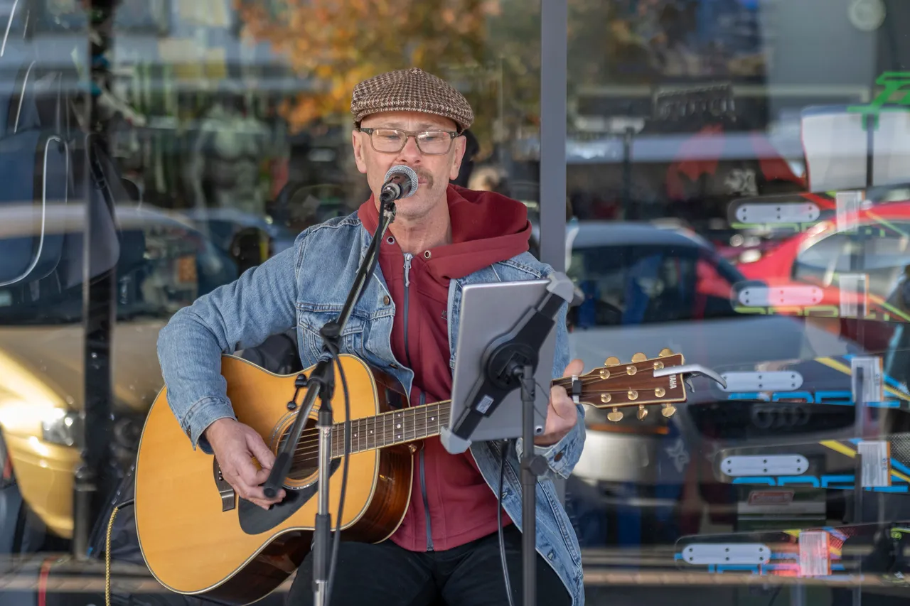 Man busking playing guitar