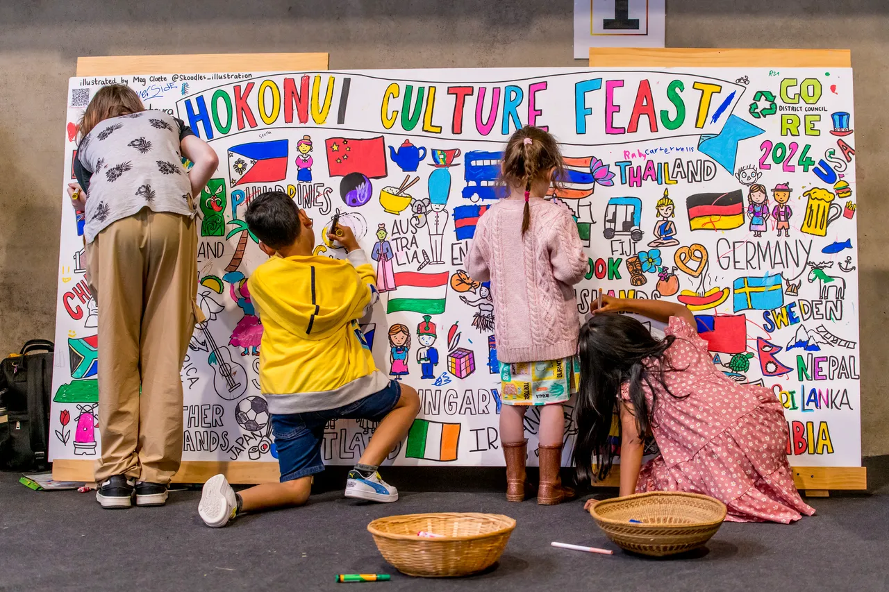 children colour in a giant mural