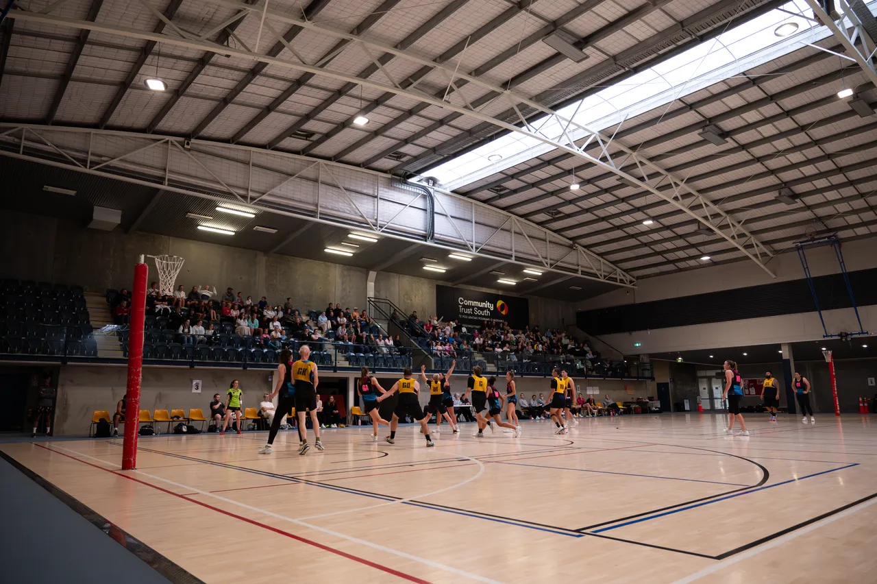 Photo of a netball team playing on a court at MLT Event Centre