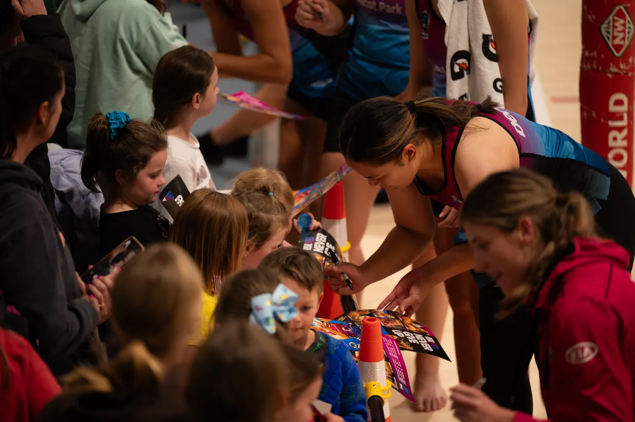 Players sign autographs for kids