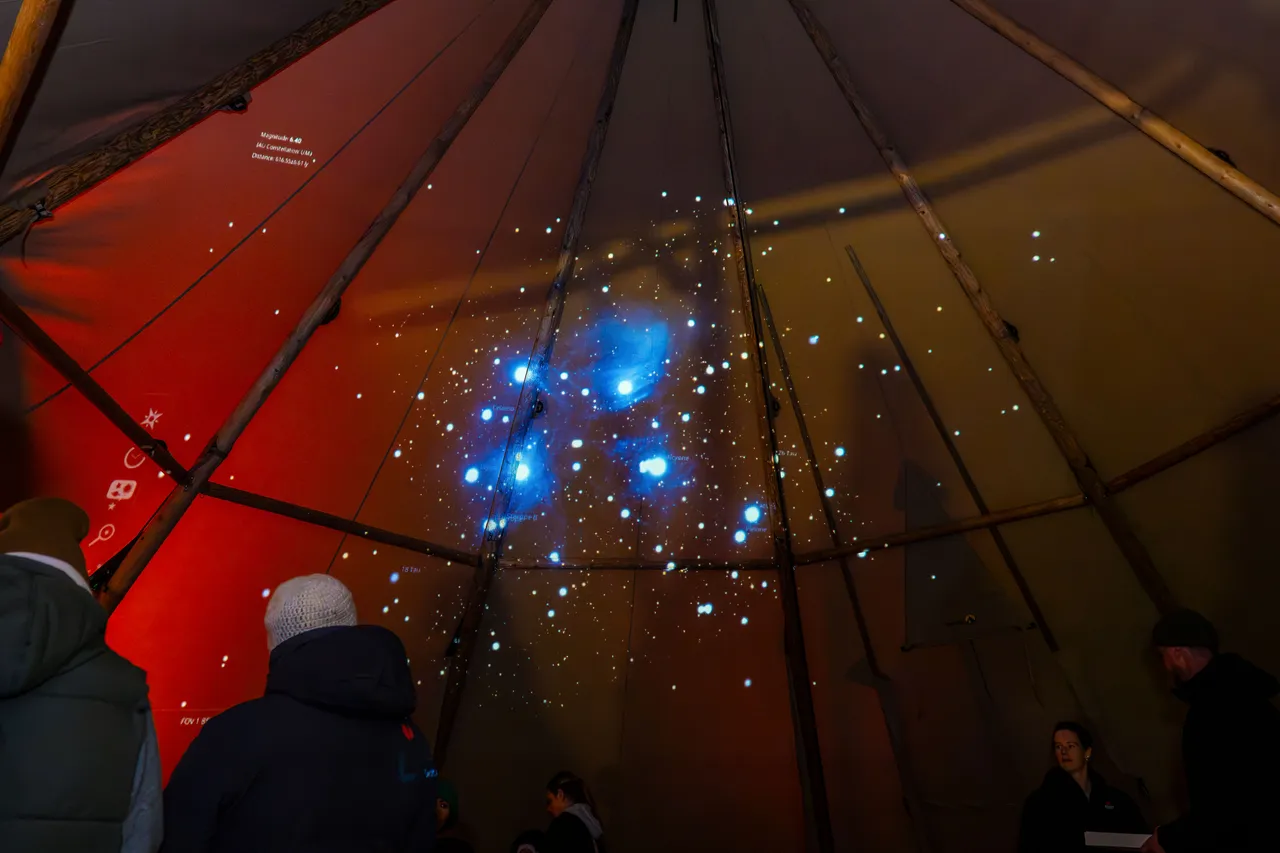 Inside tipi, stars projected onto inside wall of tipi.