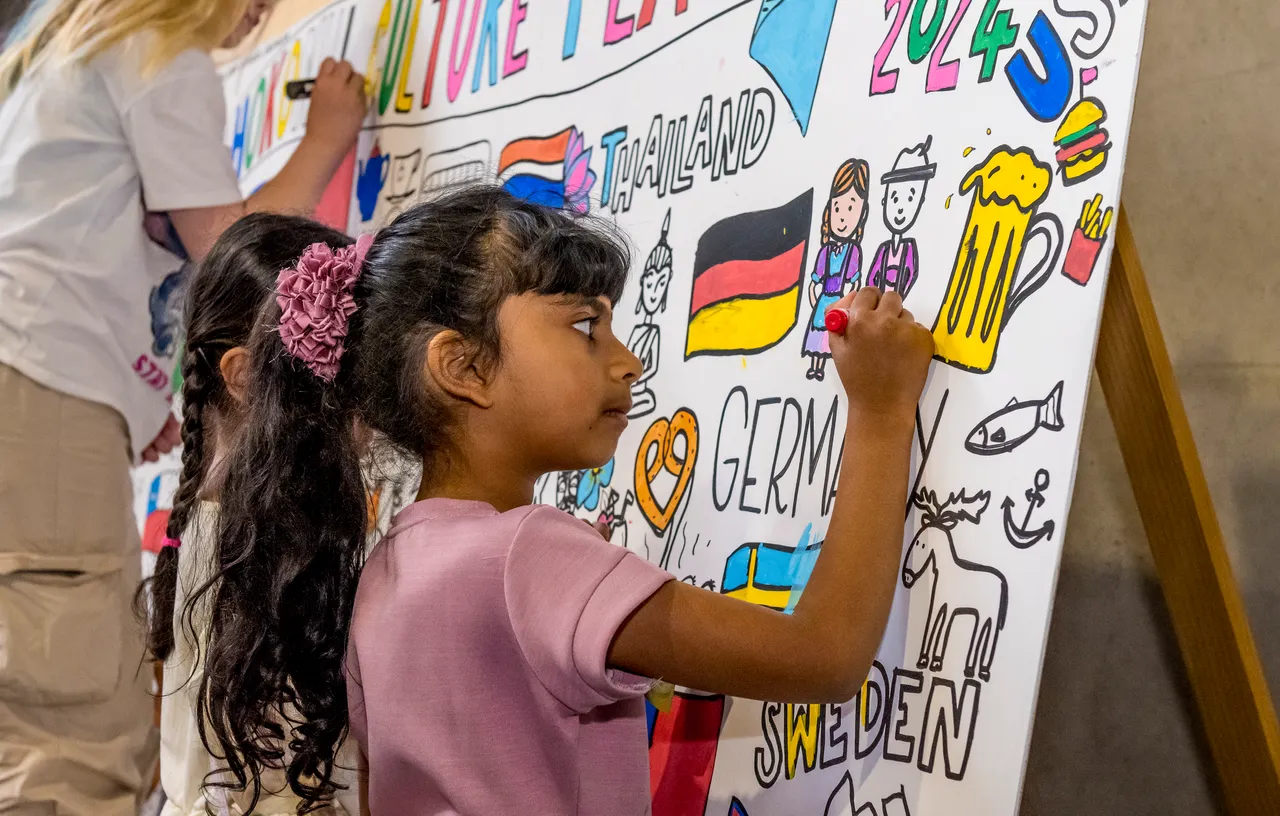 child colouring in a mural