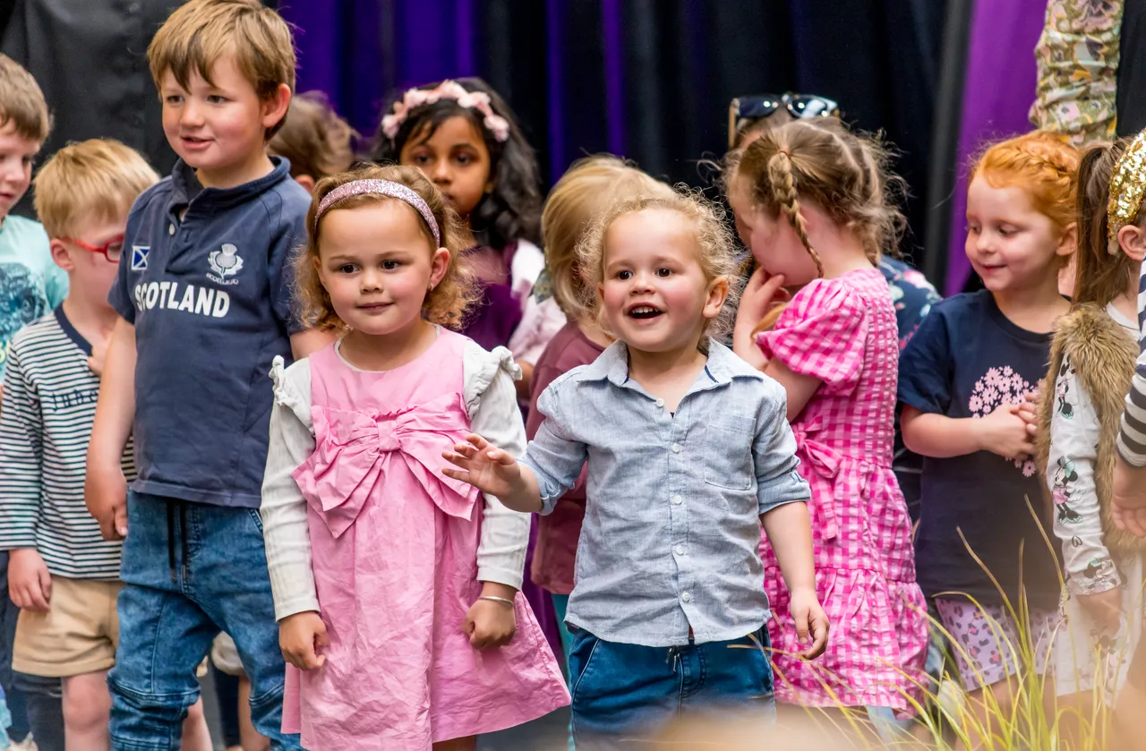 children on stage performing