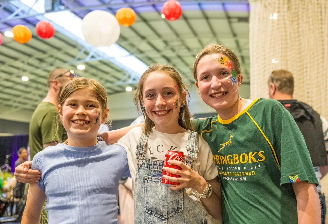 Three young girls smiling