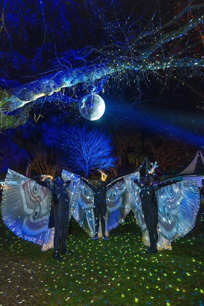 Thre people in month costumes under a discoball