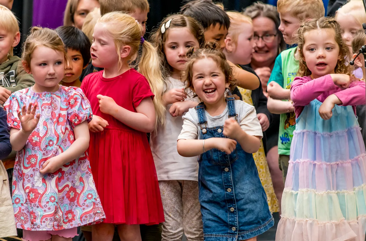 children performing on stage
