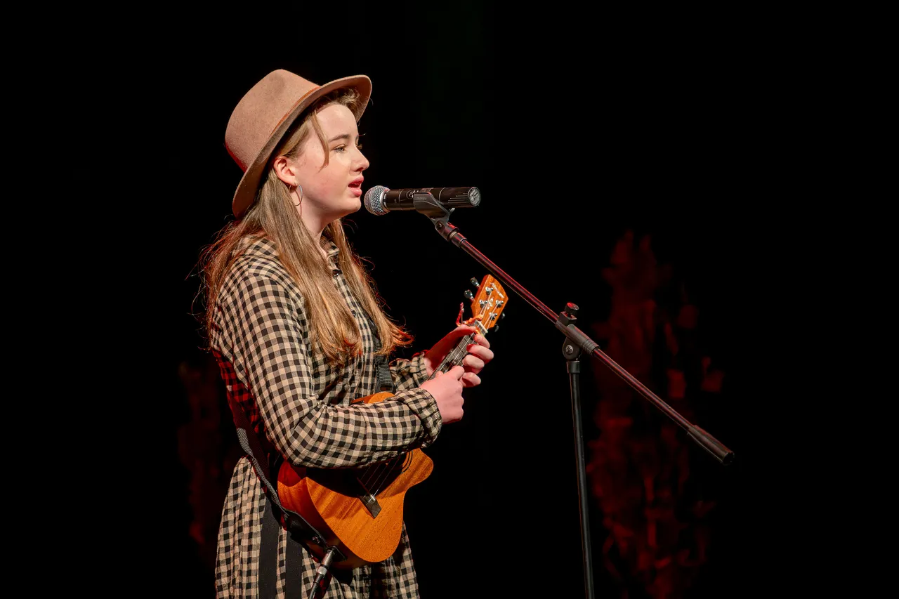 girl playing ukulele on stage