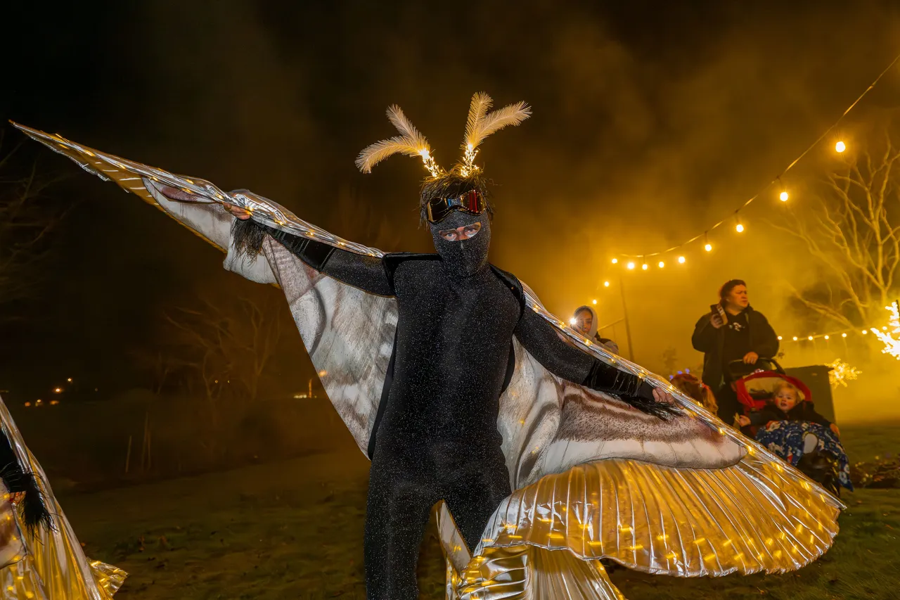 Moth dancer spreads their wings for photo