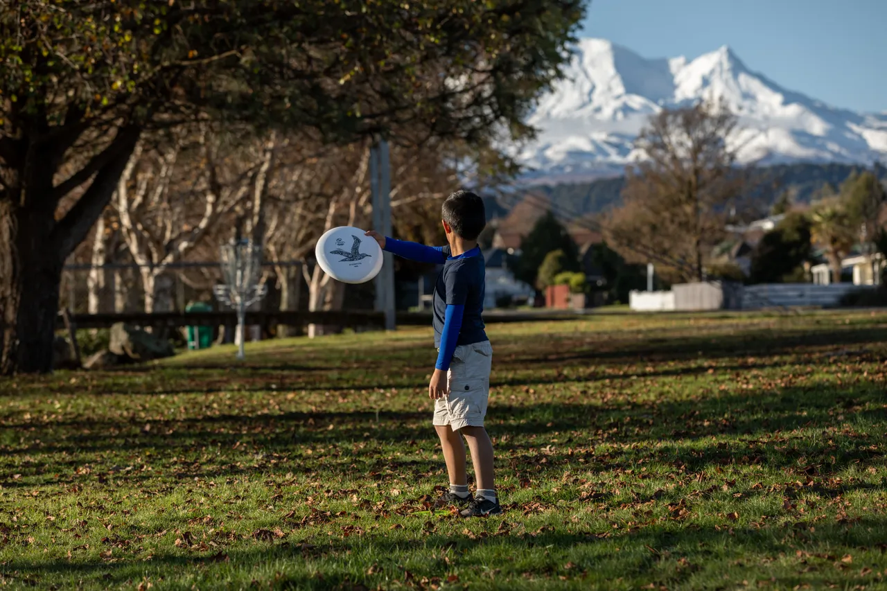 Child playing disc golf at the Mangawhero Terrace course