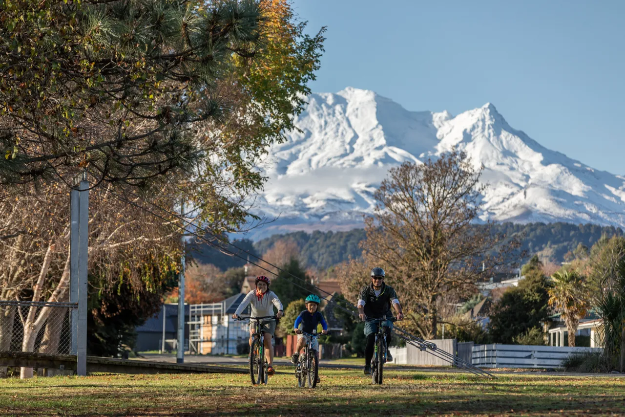 Family mountain biking with Mt Ruapehu in the background