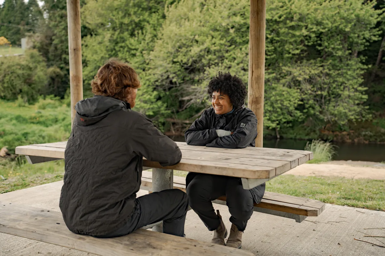 Couple Sitting at a Bench Along the Mākōtuku River Walkway