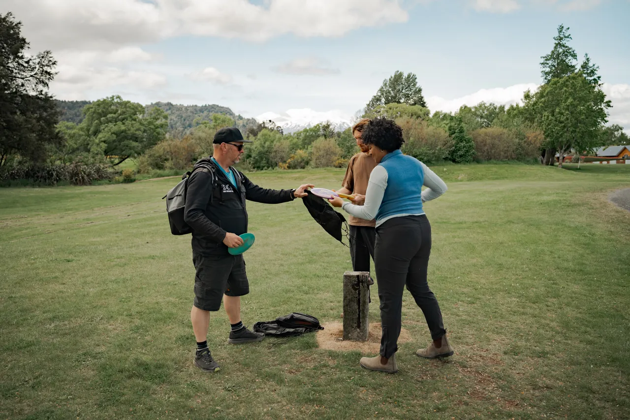 Couple Learning How to Play Disc Golf