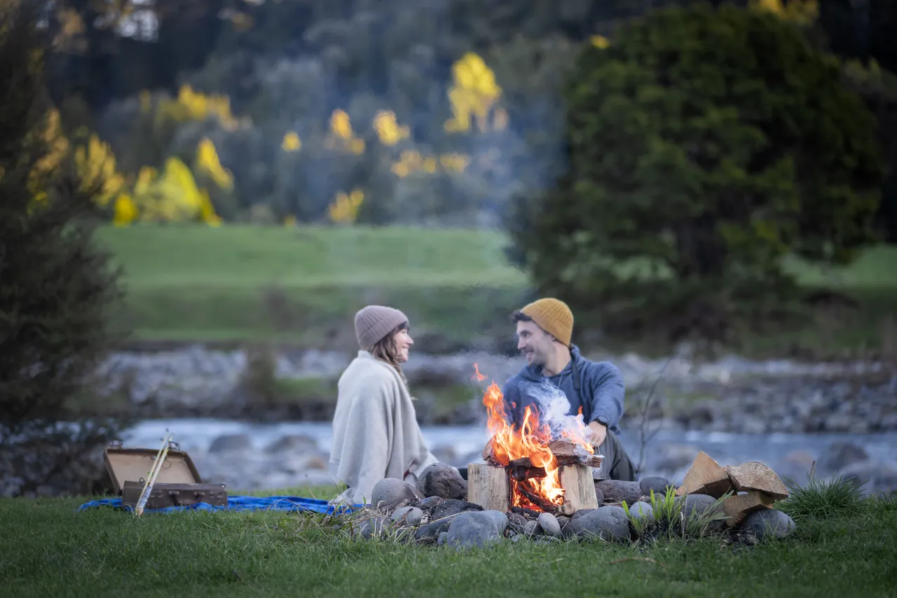 Couple Sitting by a Fire Beside the Whanganui River