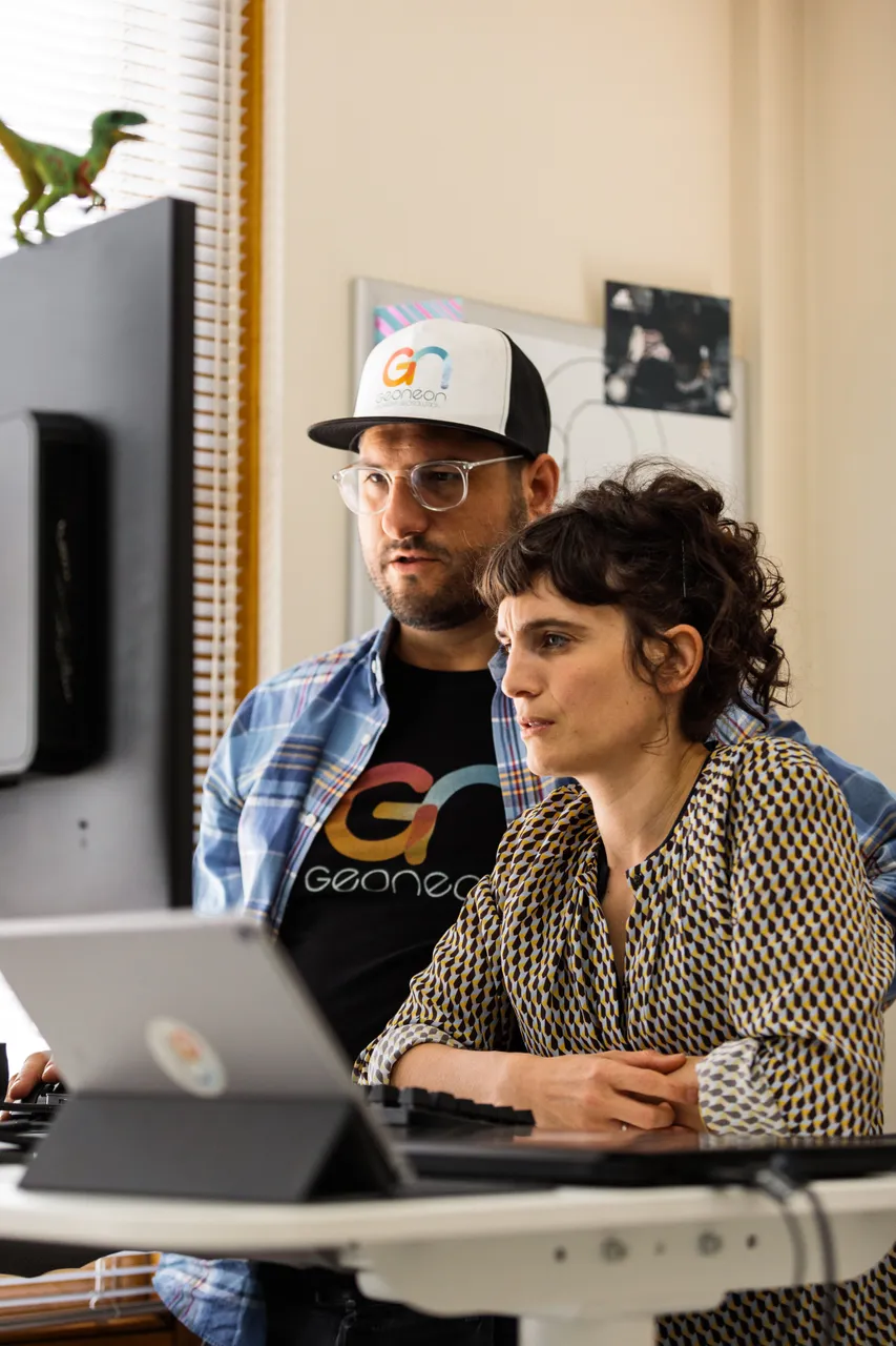 Geoneon Working at Computer