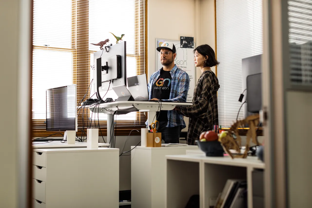 Geoneon Working at Computer