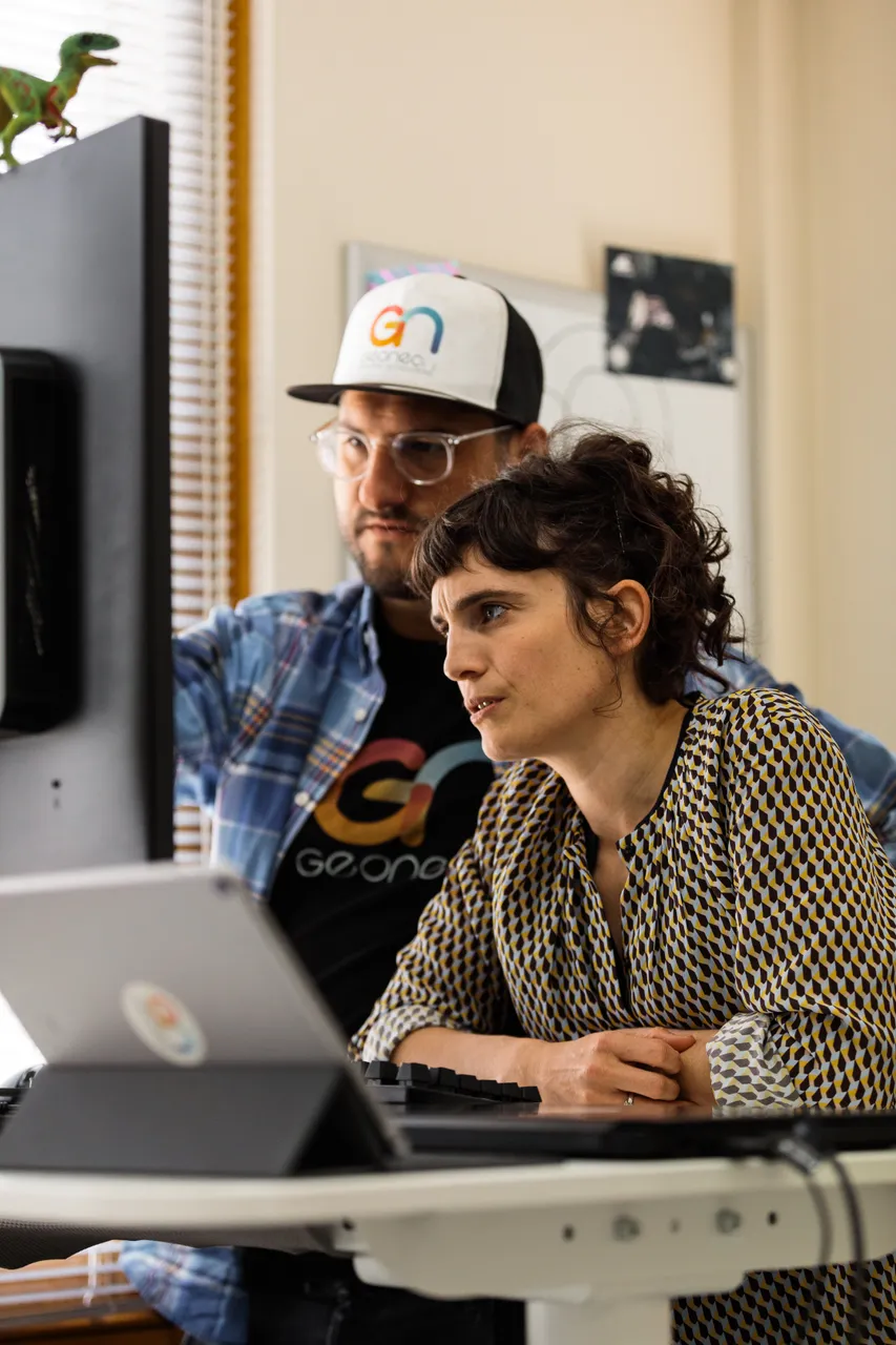 Geoneon Working at Computer