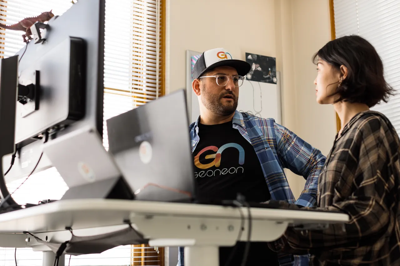 Geoneon Working at Computer