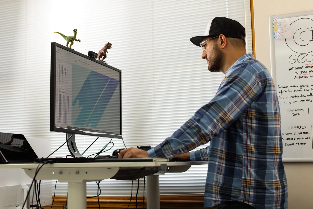 Geoneon Working at Computer