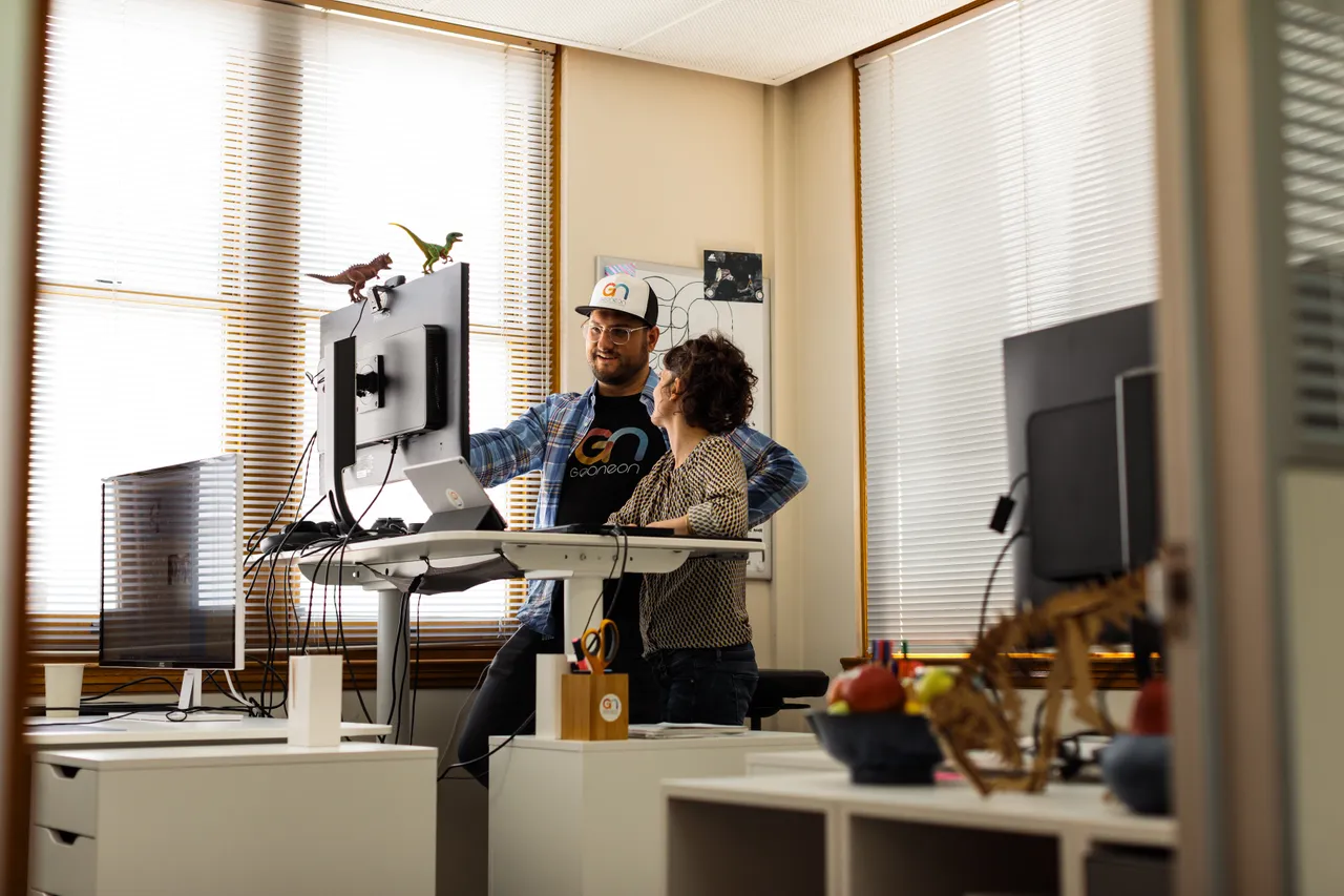 Geoneon Working at Computer