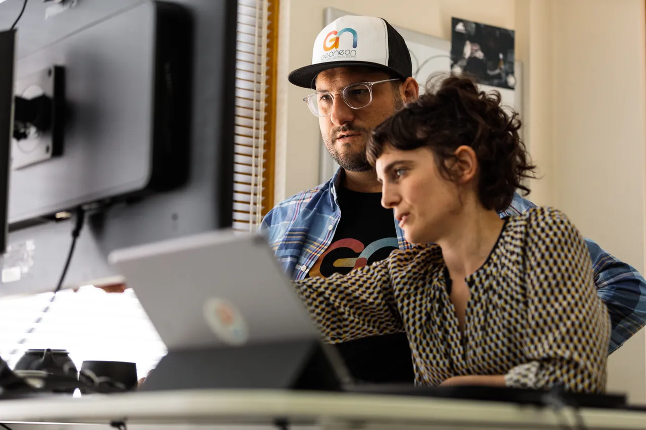 Geoneon Working at Computer