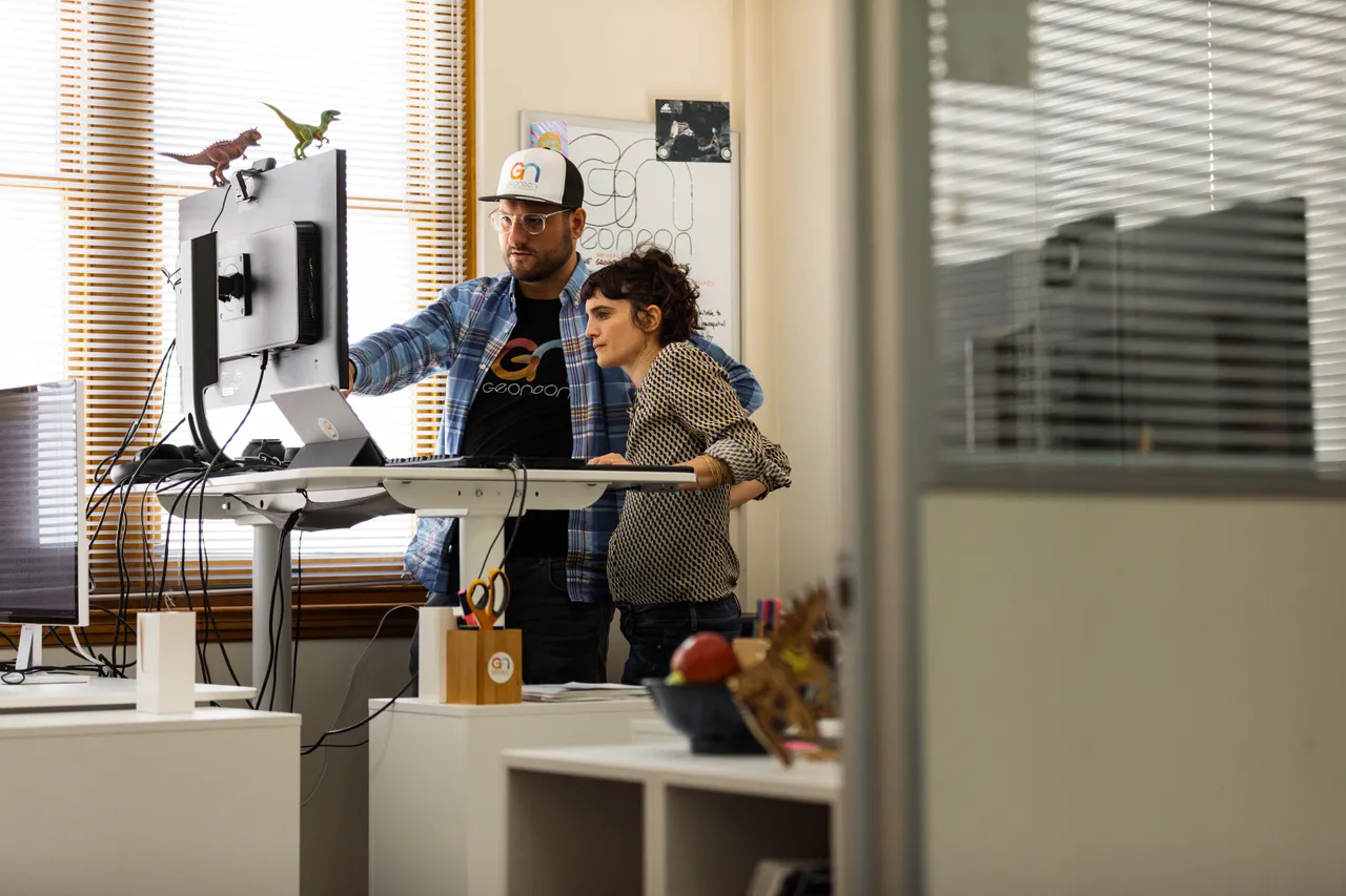 Geoneon Working at Computer