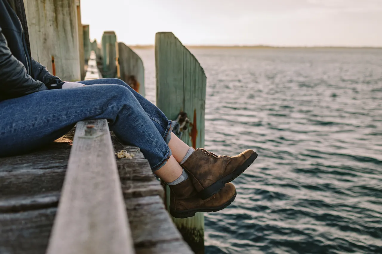 Person Sitting on Pier