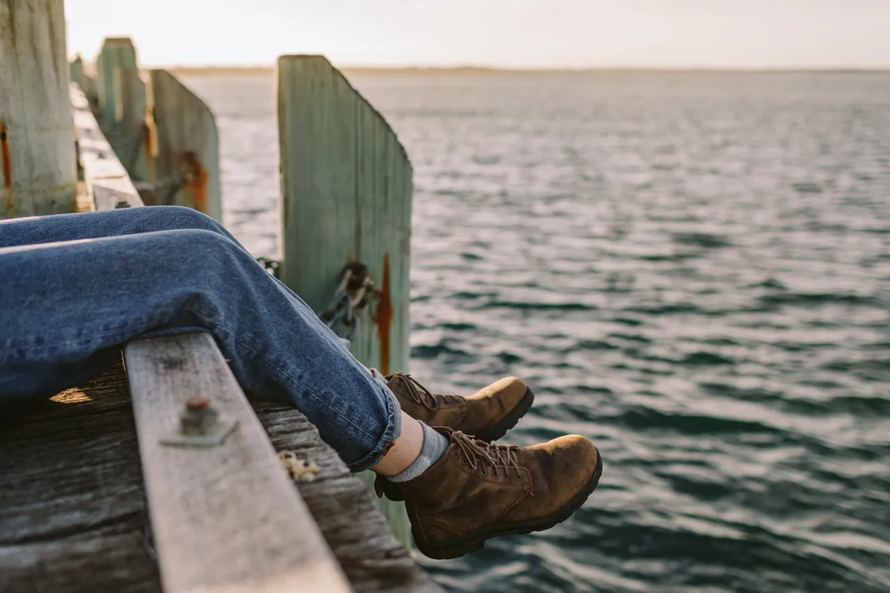 Person Sitting on Pier