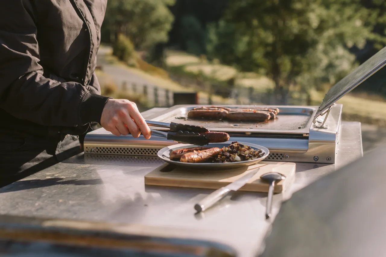 Person Plating Sausages