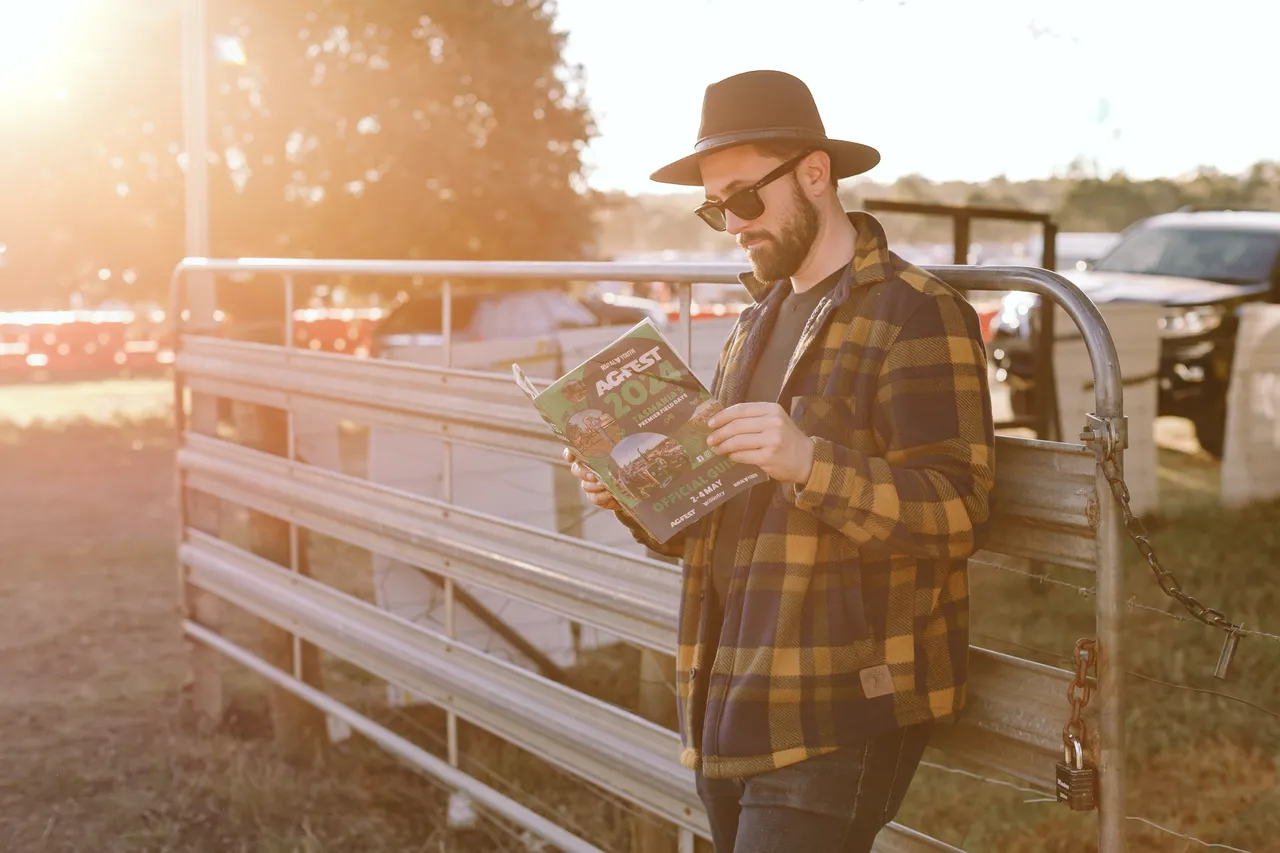 Person Reading Agfest Brochure