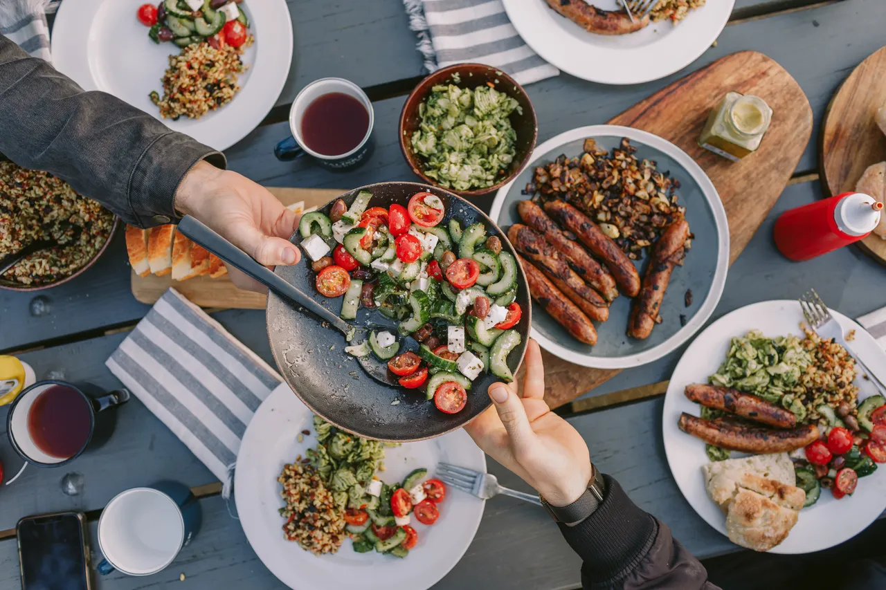 Passing Salad at Picnic Table