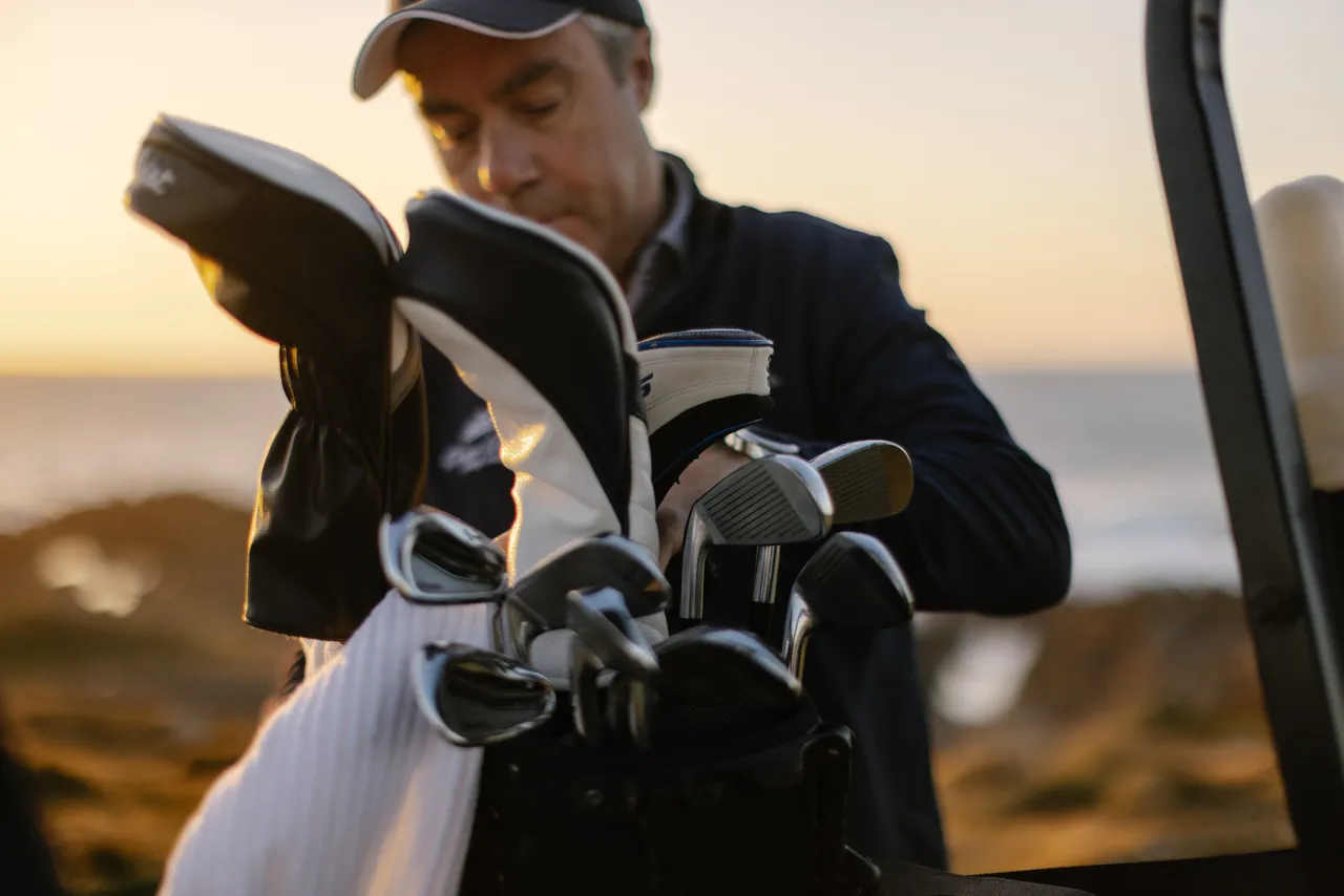 Golfer Sorting Clubs