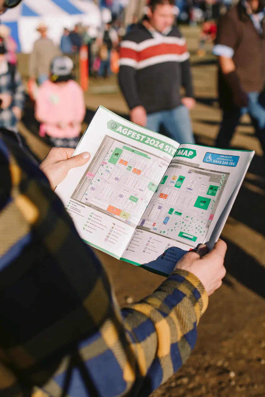 Person Reading Agfest Brochure