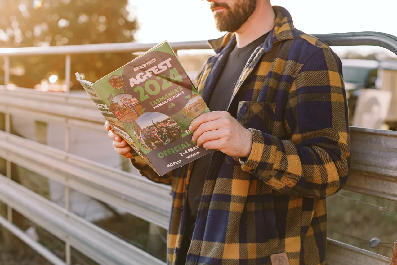 Person Reading Agfest Brochure
