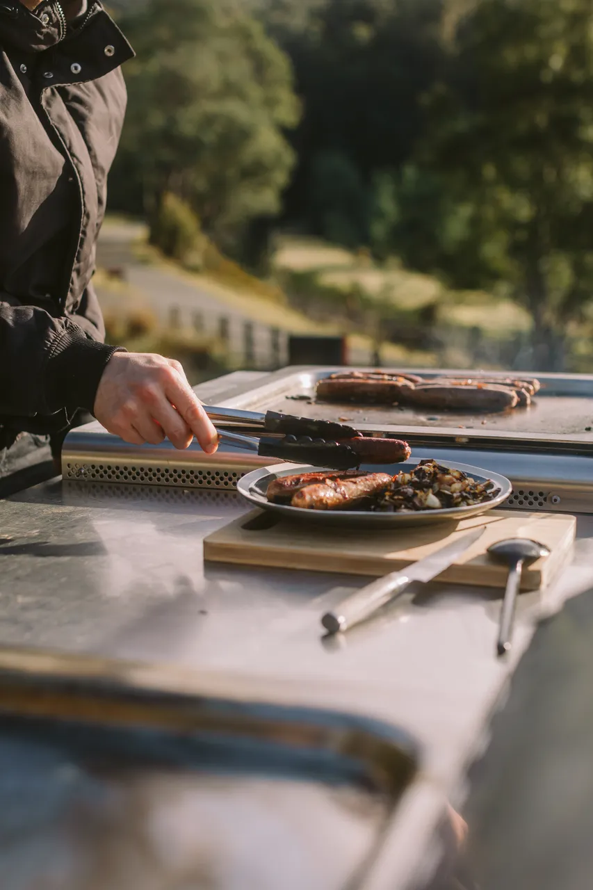Person Plating Sausages