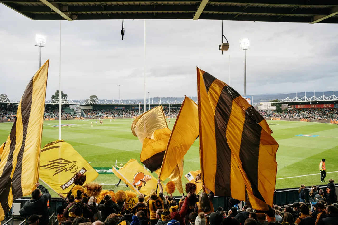 Utas Flag Tasmanian Partner Toolkit - Waving Hawks Flags at UTAS Stadium