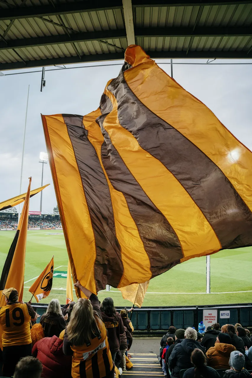 Utas Flag Tasmanian Partner Toolkit - Waving Hawks Flags at UTAS Stadium