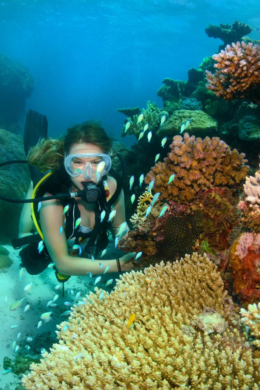 European female underwater shot with coral reefs