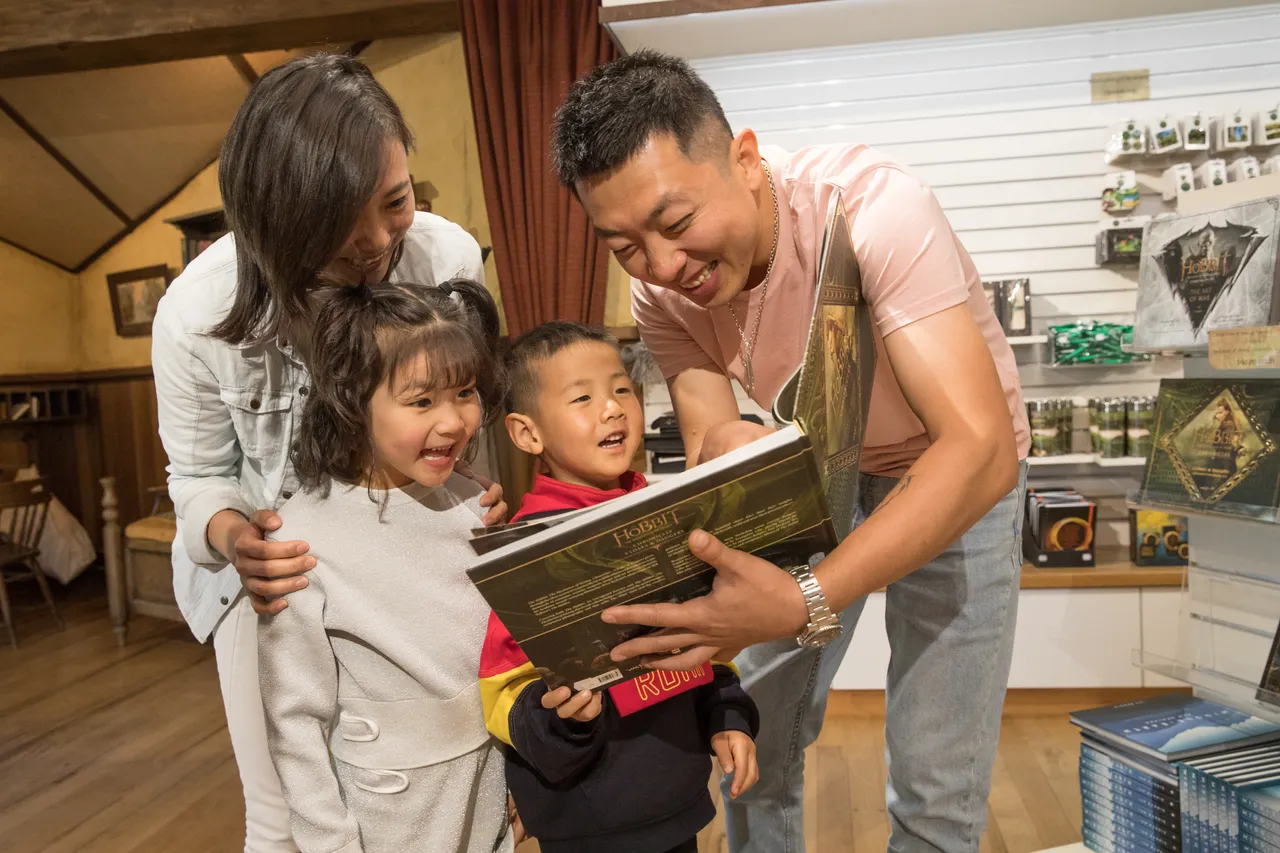 Chinese family looking at LOTR books