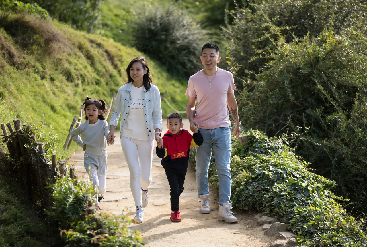 Chinese family walking at the Hobbiton Movie Set