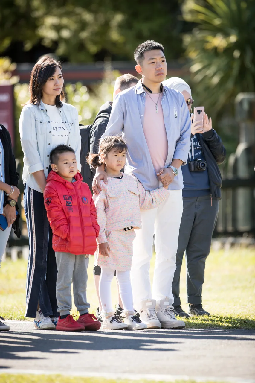 Chinese family watching marae welcoming ceremony