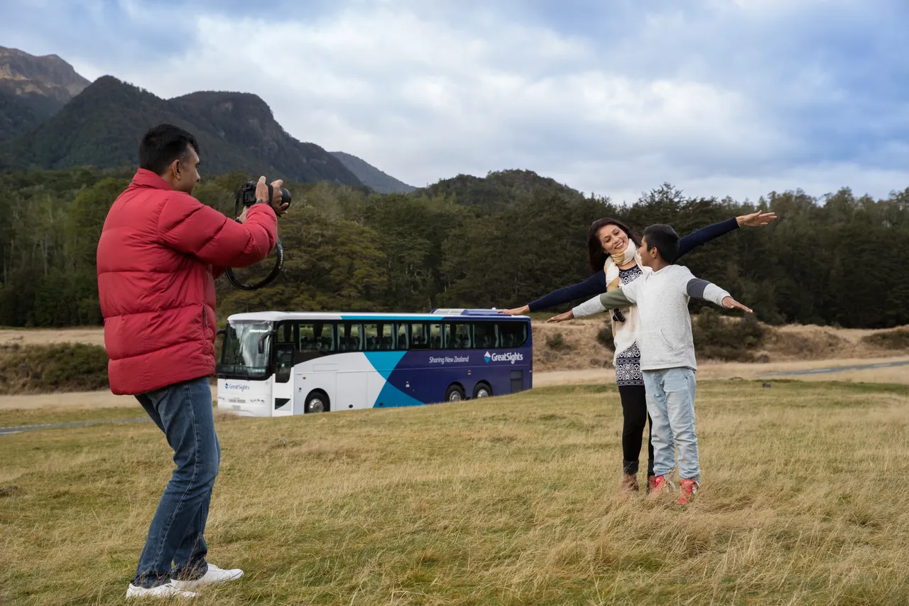 Indian family taking group photo at Eglinton Valley