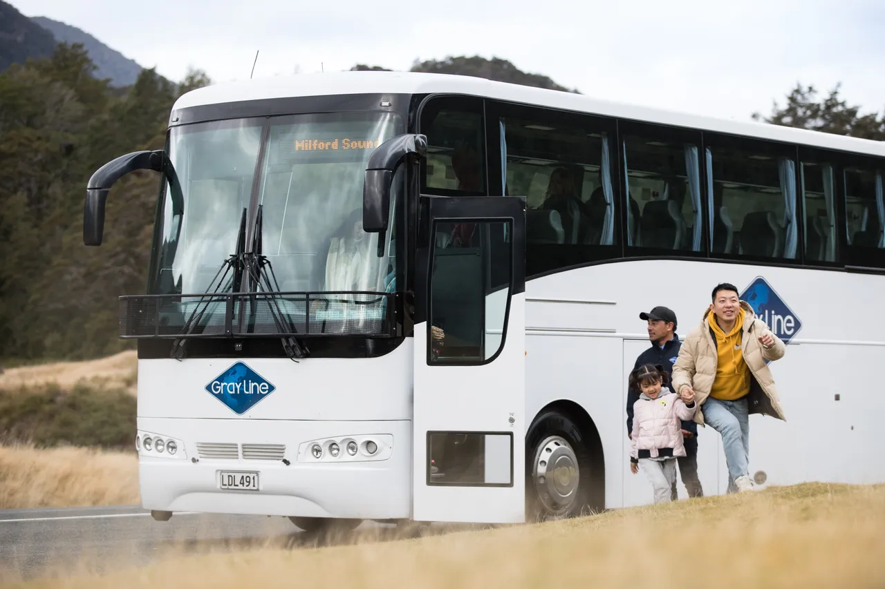 Chinese family getting off Grayline coach at Eglinton Valley