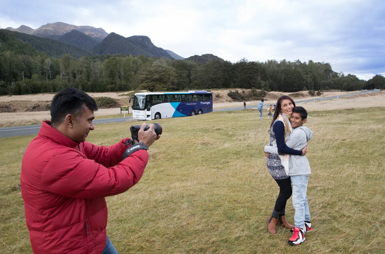 Indian family taking group photo at Eglinton Valley
